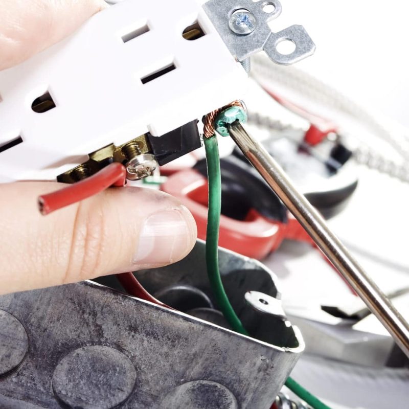 Electrician Stock image of Electrician installing a power outlet.